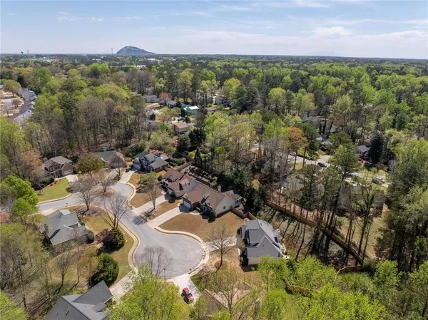 an aerial view of a houses with a yard