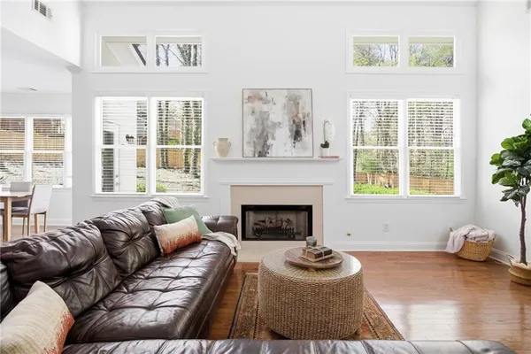 a living room with furniture a flat screen tv and a fireplace