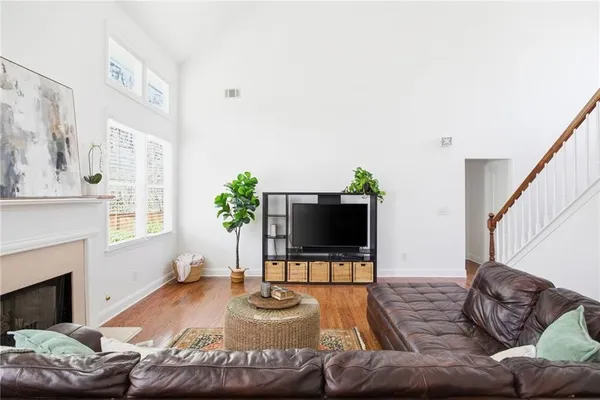 a living room with furniture a fireplace and a flat screen tv