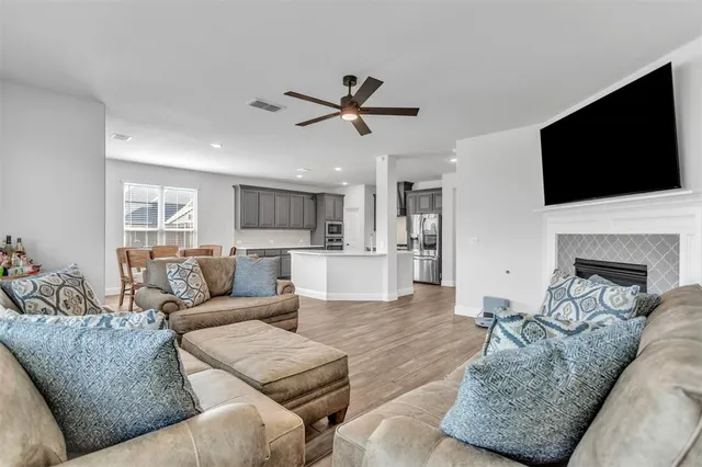 a living room with furniture fireplace and a flat screen tv