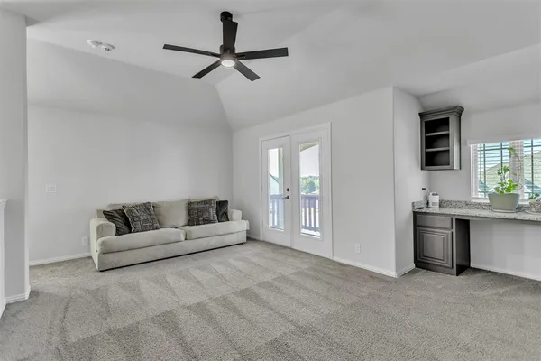 a living room with furniture and a ceiling fan