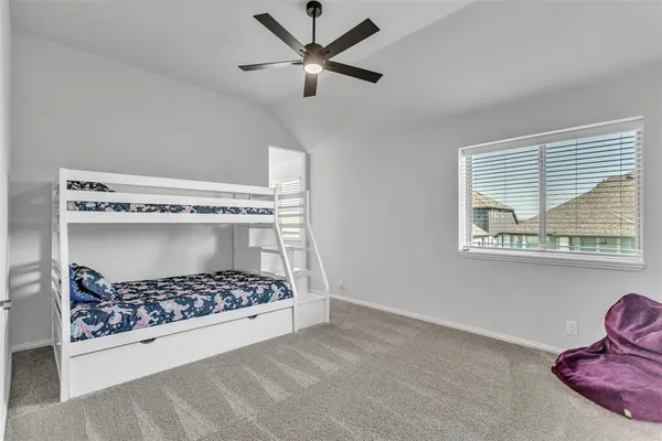 a living room with a baby bed furniture and a window