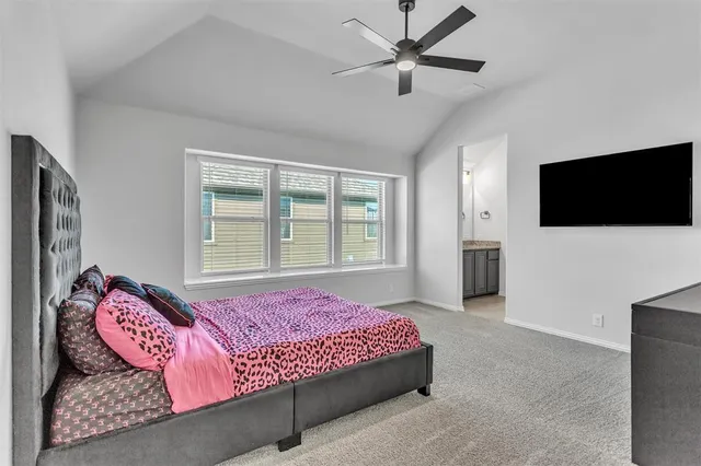 a bedroom with a bed and a flat screen television