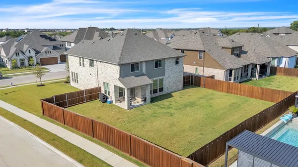 an aerial view of residential houses with outdoor space and seating