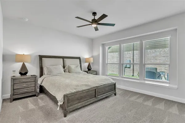 a bedroom with a large bed and a large window