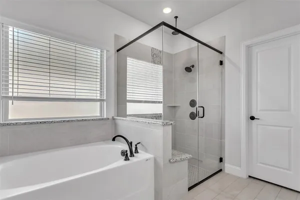 a bathroom with a bathtub and a shower
