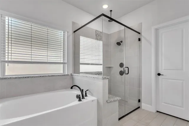 a bathroom with a bathtub and a shower