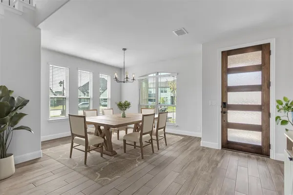 a view of a dining room with furniture window and wooden floor