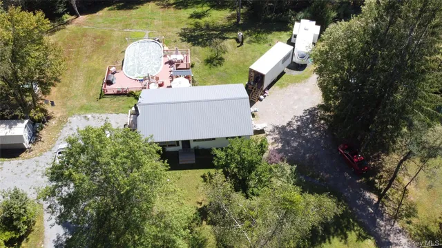 an aerial view of a house with a yard and outdoor seating
