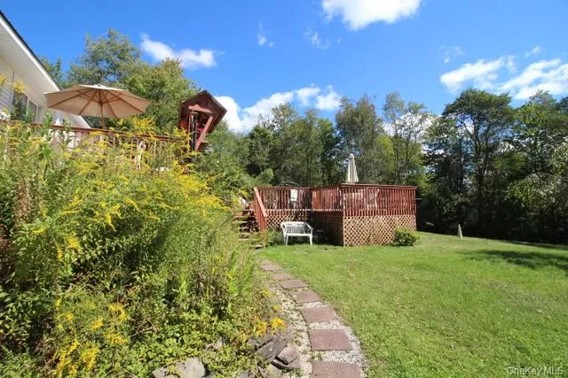 a view of a backyard with table and chairs and potted plants