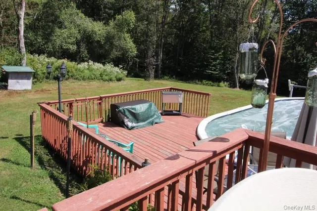 a view of deck with furniture and trees