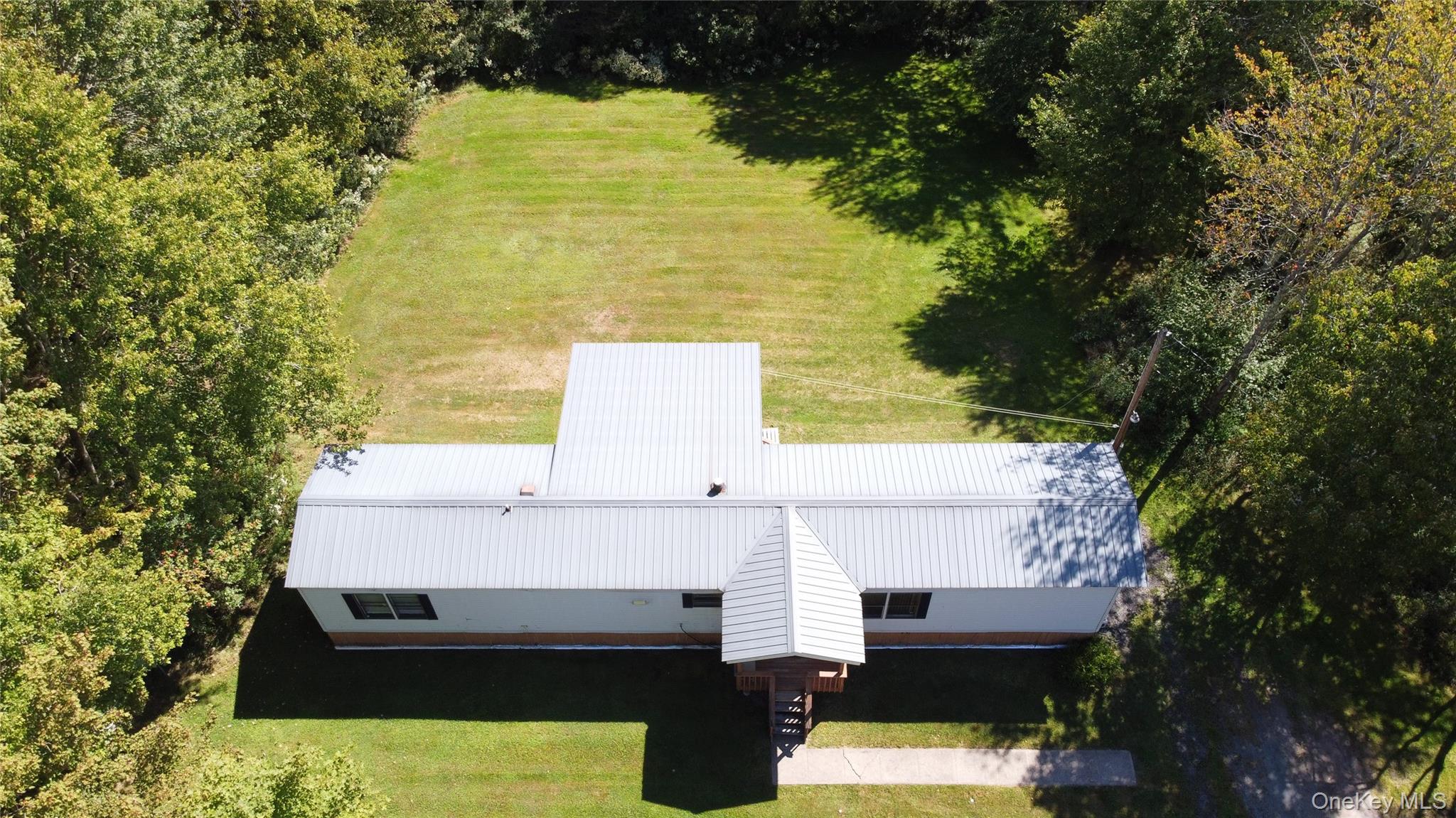 226 Goff Road, Unit 24 Livingston Manor, NY 12758 - Photo 8 of 49 a view of a balcony with two chairs and a table