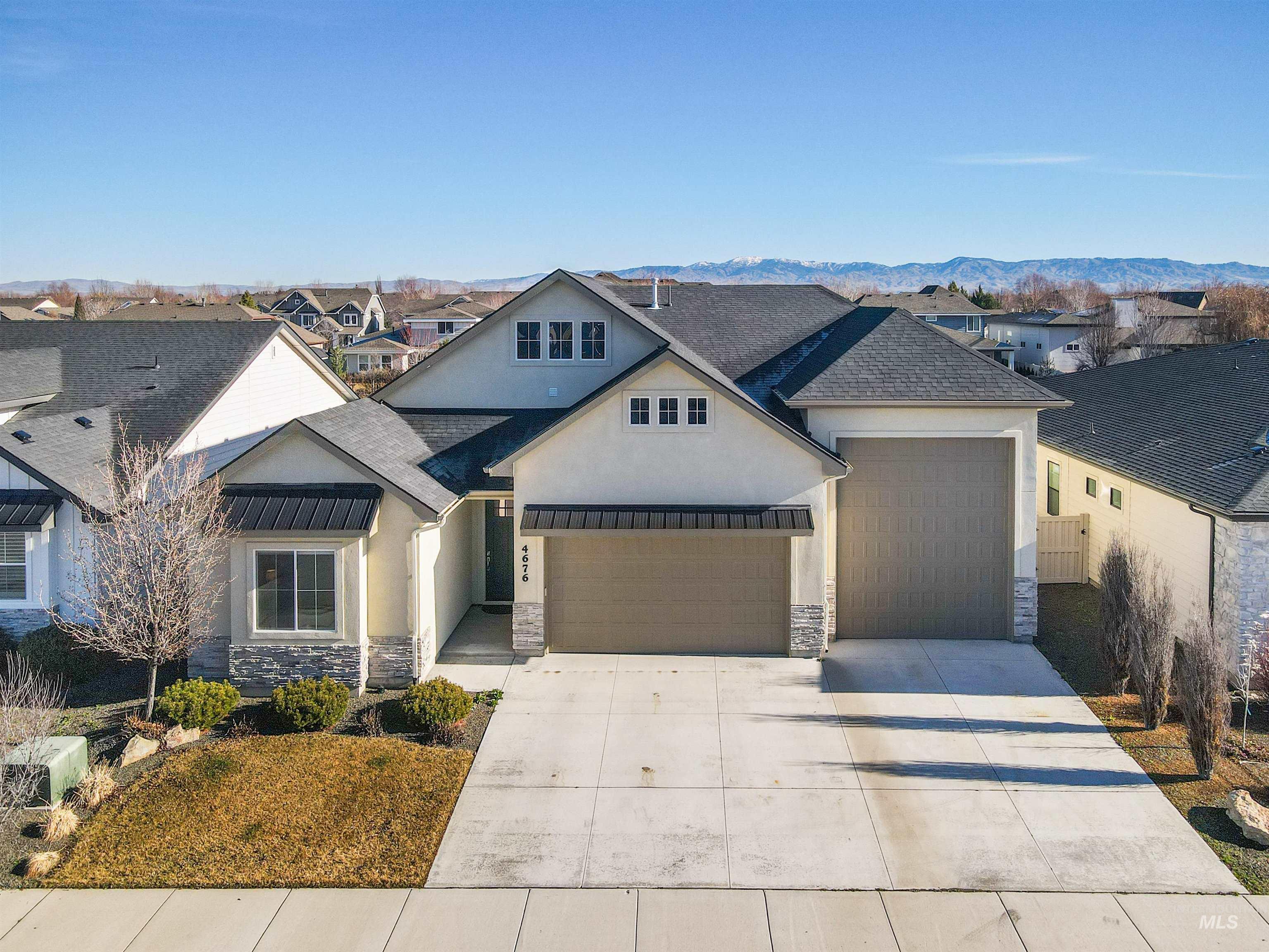 4676 South Abbot Meridian, ID 83642 - Photo 1 of 49 View of front of property with stone siding, stucco siding, a residential view, and a standing seam roof