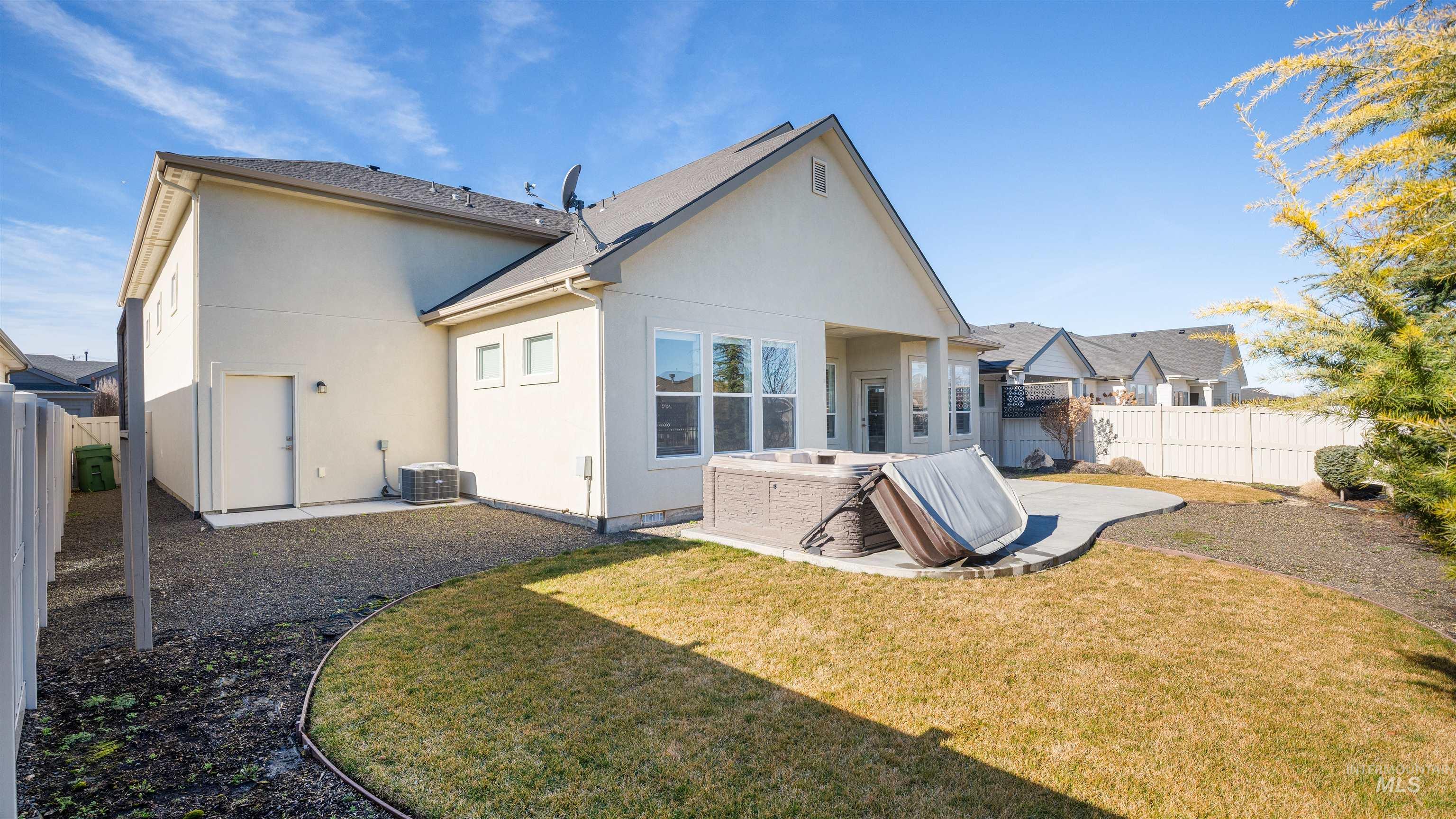 4676 South Abbot Meridian, ID 83642 - Photo 11 of 49 Rear view of house with a fenced backyard, a patio area, and stucco siding