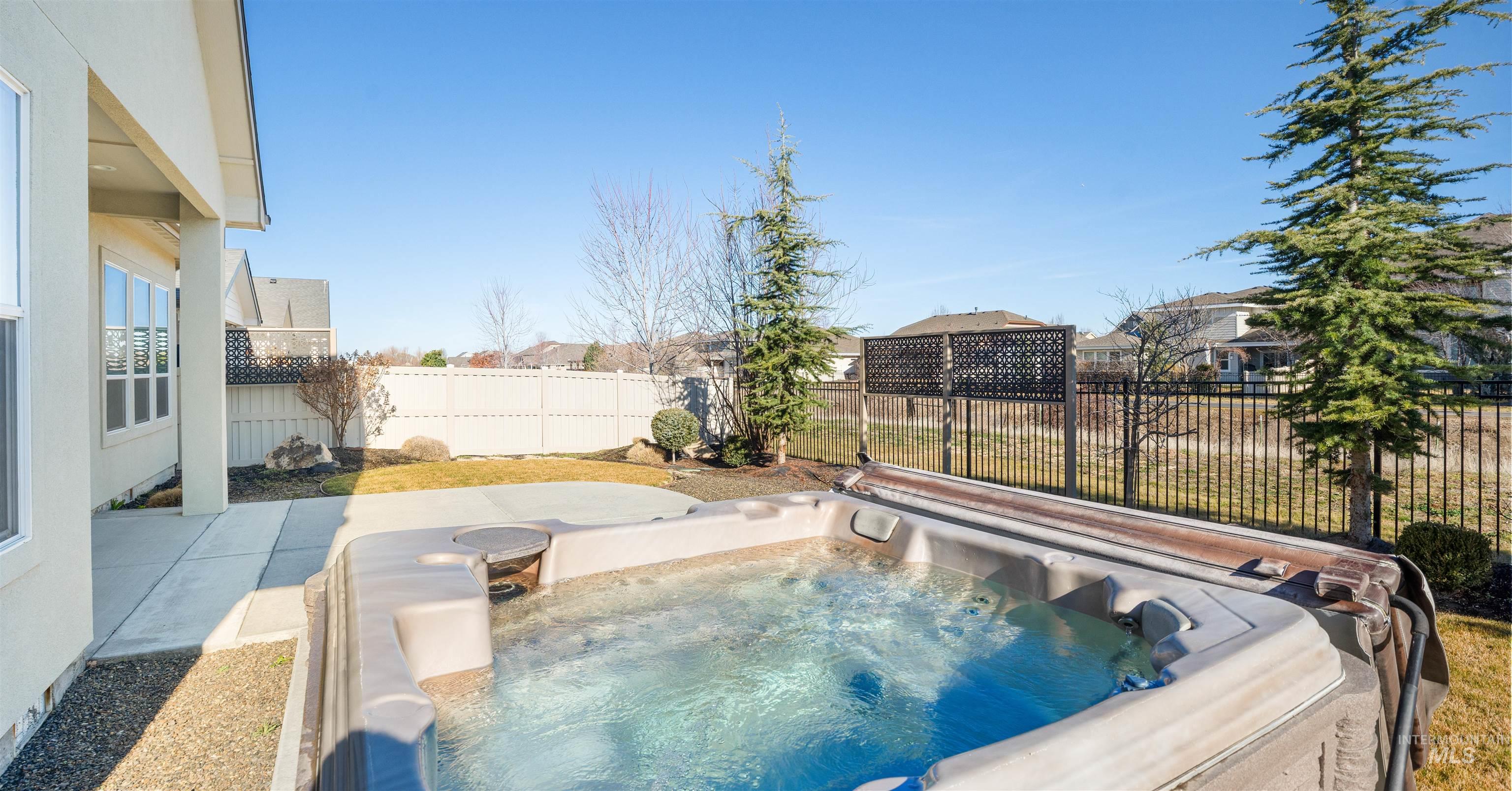 4676 South Abbot Meridian, ID 83642 - Photo 13 of 49 View of pool with a fenced backyard, patio surround, and a hot tub
