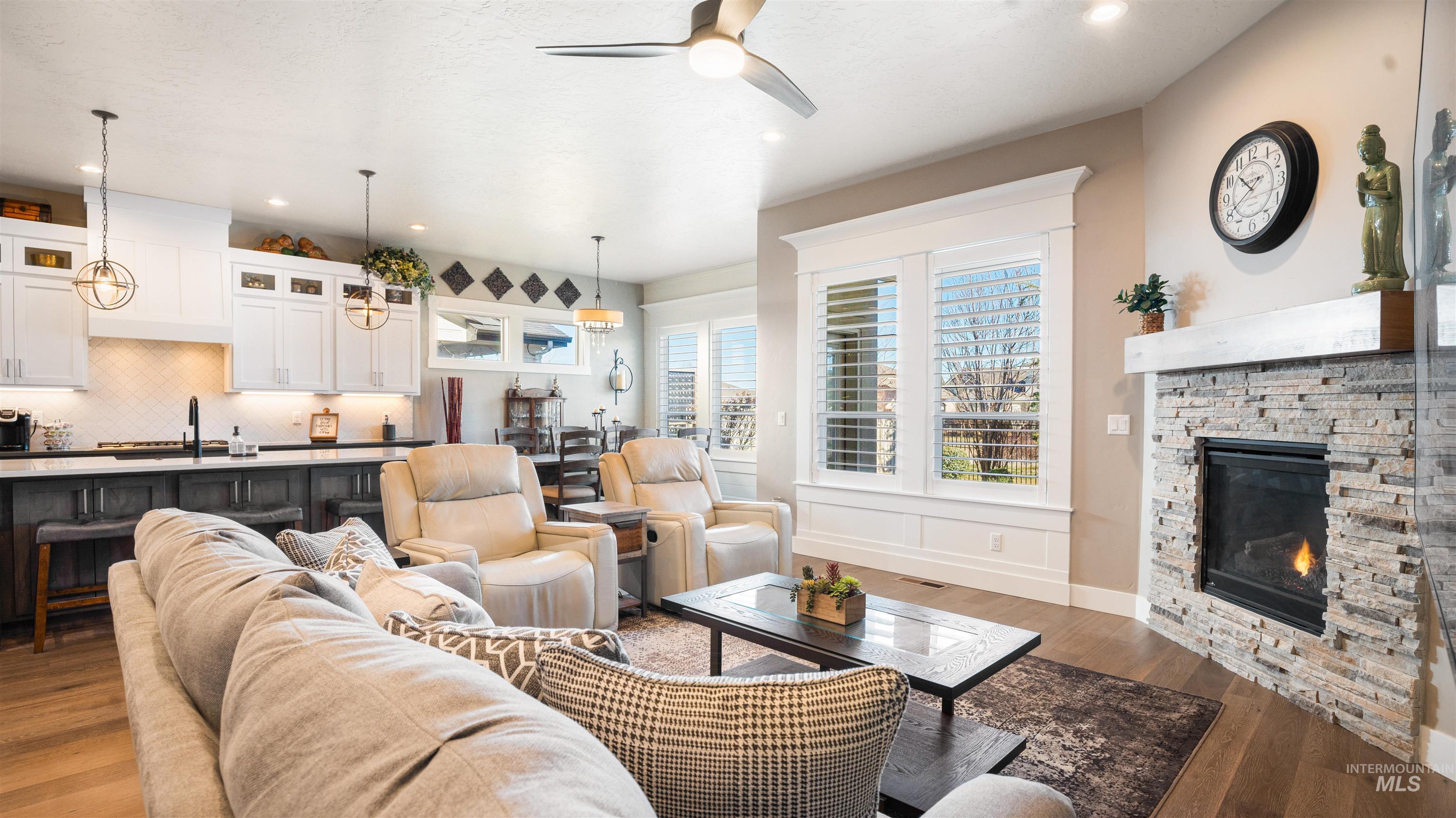 4676 South Abbot Meridian, ID 83642 - Photo 19 of 49 Living room featuring wood finished floors, a ceiling fan, a fireplace, and recessed lighting
