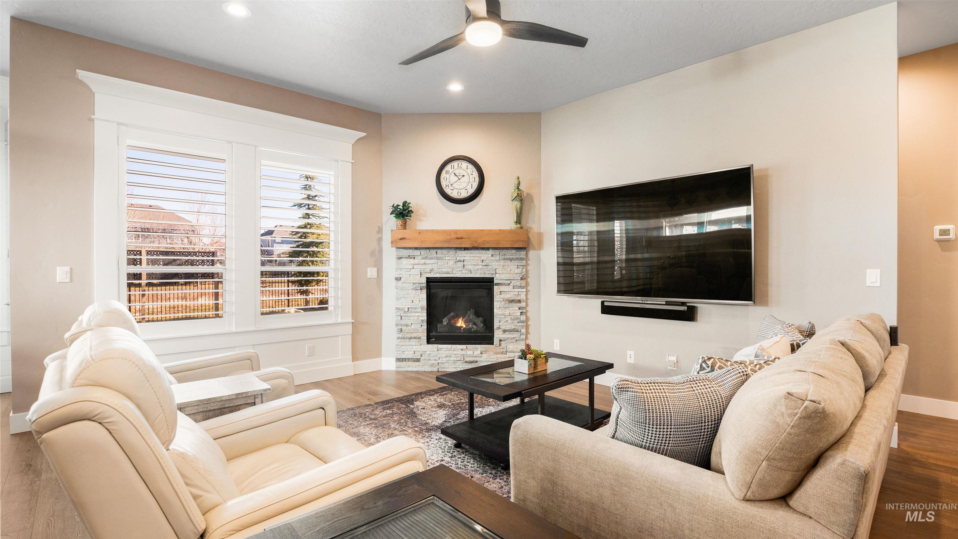 4676 South Abbot Meridian, ID 83642 - Photo 20 of 49 Living area with a ceiling fan, wood finished floors, a fireplace, and recessed lighting