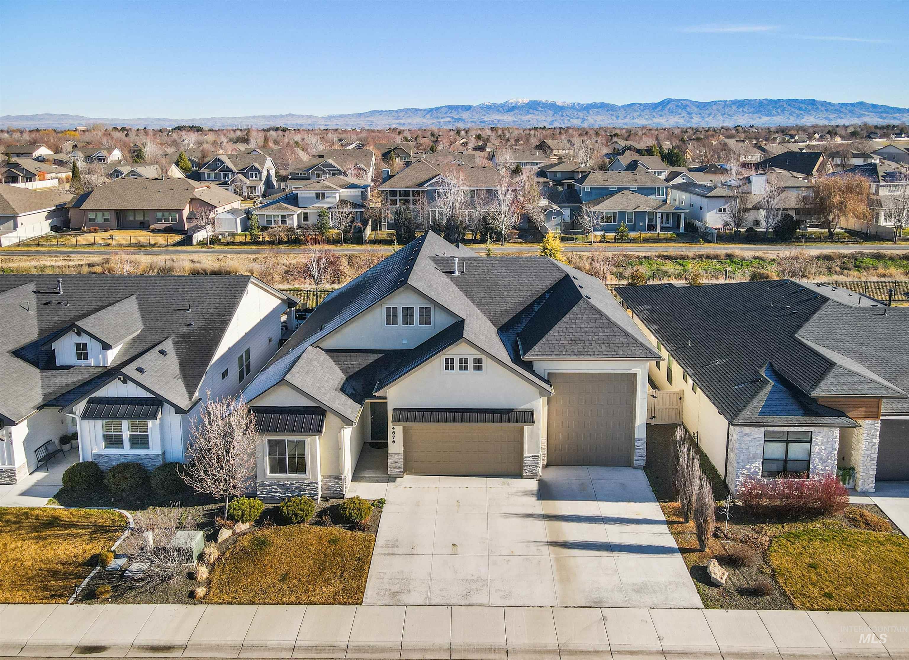 4676 South Abbot Meridian, ID 83642 - Photo 2 of 49 View of front facade featuring stone siding, stucco siding, and driveway