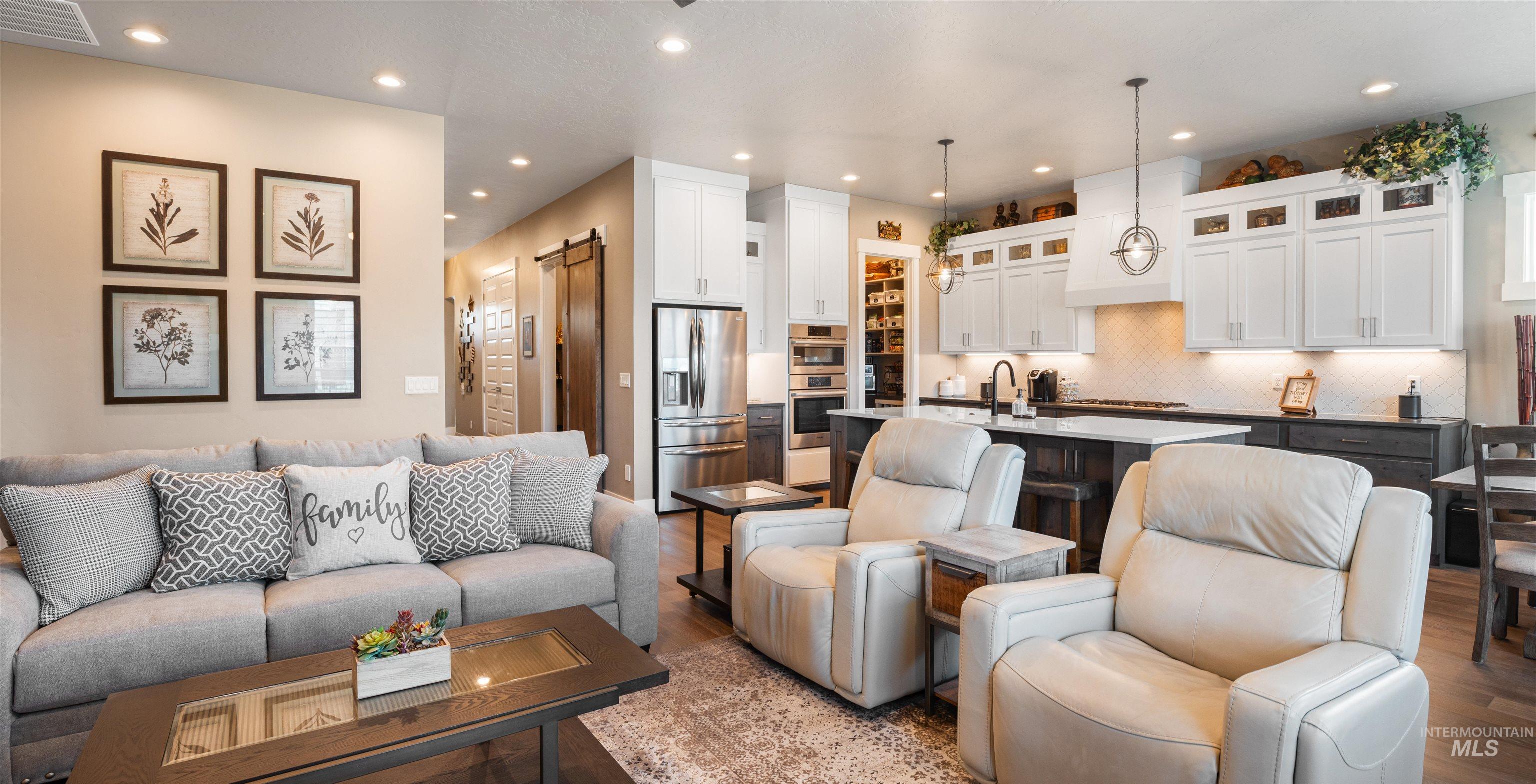 4676 South Abbot Meridian, ID 83642 - Photo 22 of 49 Living room with a barn door, recessed lighting, and light wood-style floors