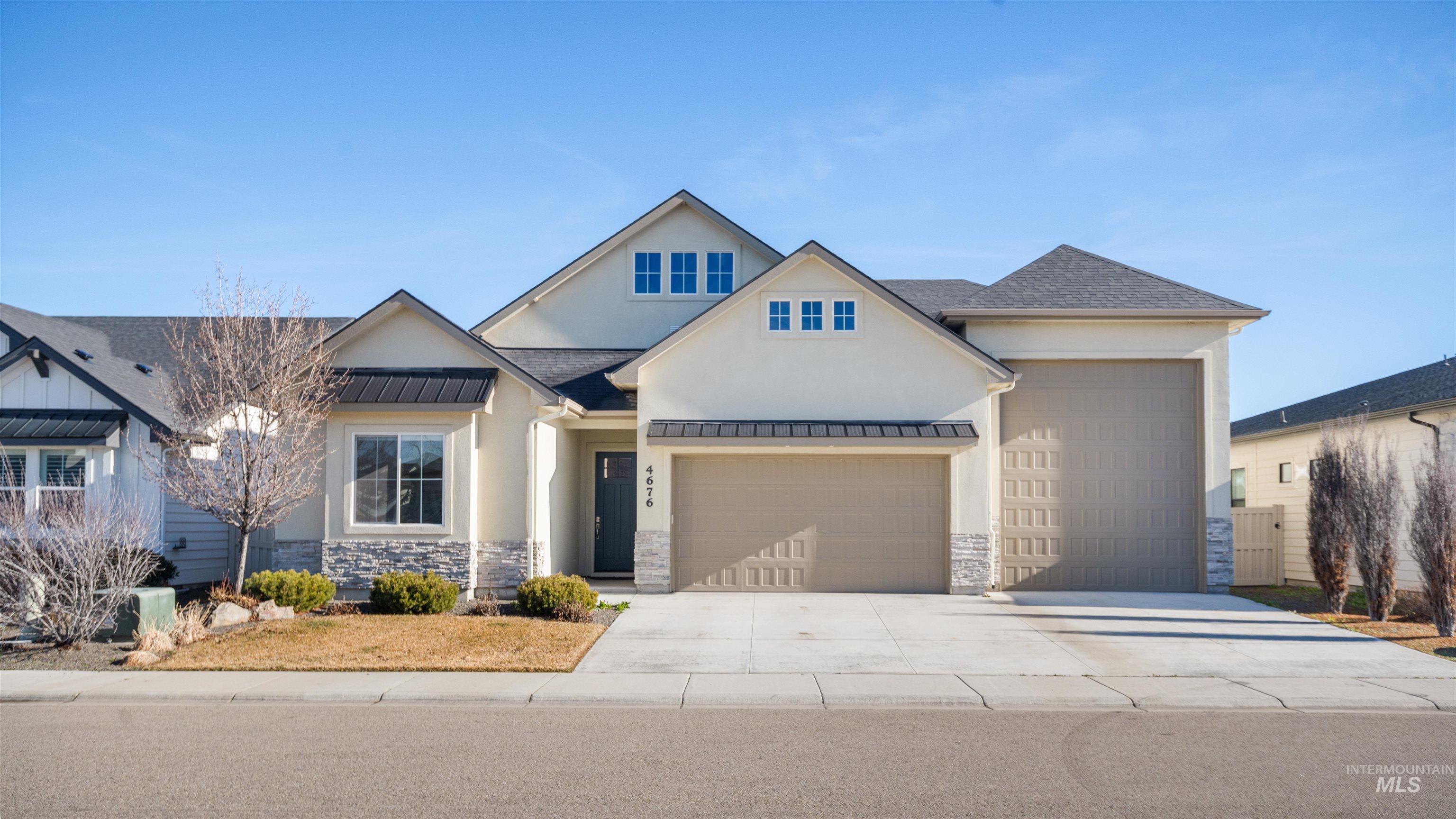 4676 South Abbot Meridian, ID 83642 - Photo 3 of 49 Modern farmhouse with a standing seam roof, stone siding, driveway, a garage, and stucco siding