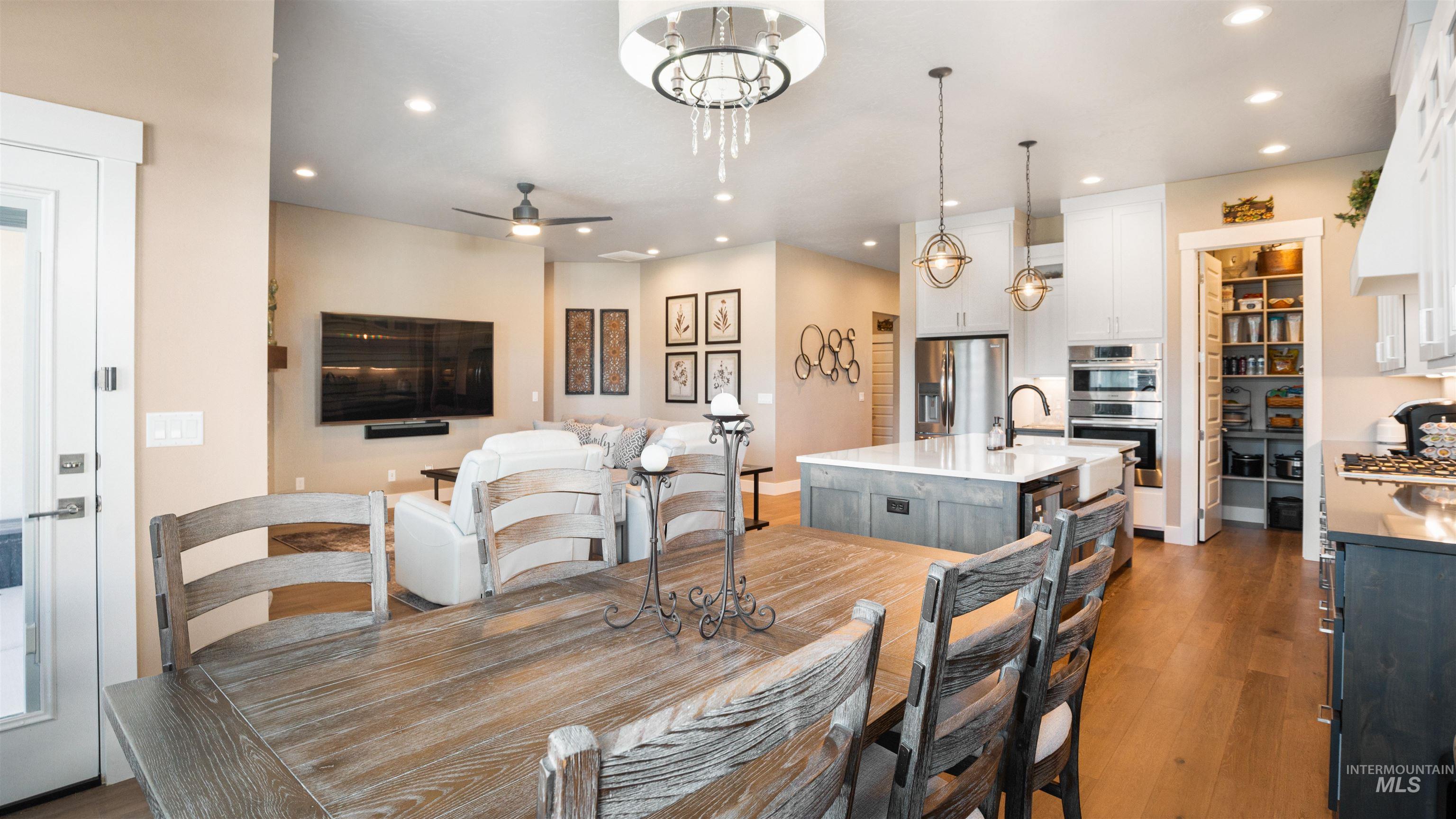 4676 South Abbot Meridian, ID 83642 - Photo 30 of 49 Dining area featuring dark wood-style flooring, a ceiling fan, and suspended lighting