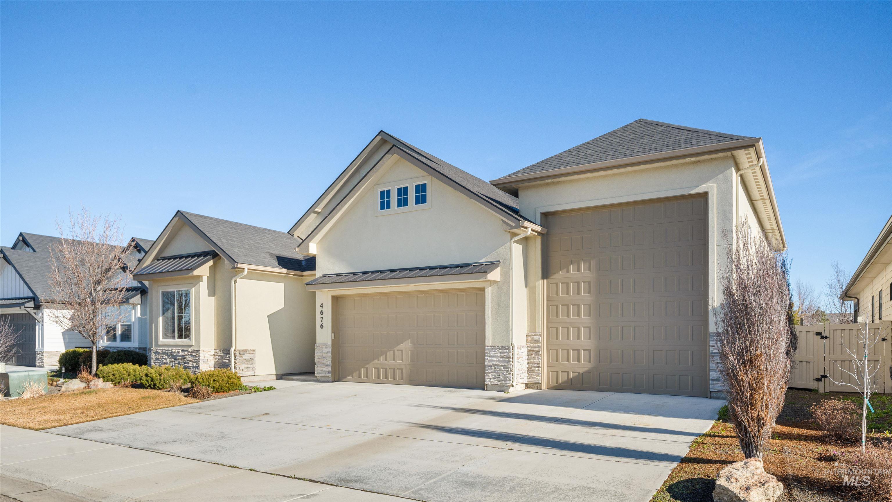 4676 South Abbot Meridian, ID 83642 - Photo 4 of 49 View of front facade with stucco siding, a gate, and concrete driveway