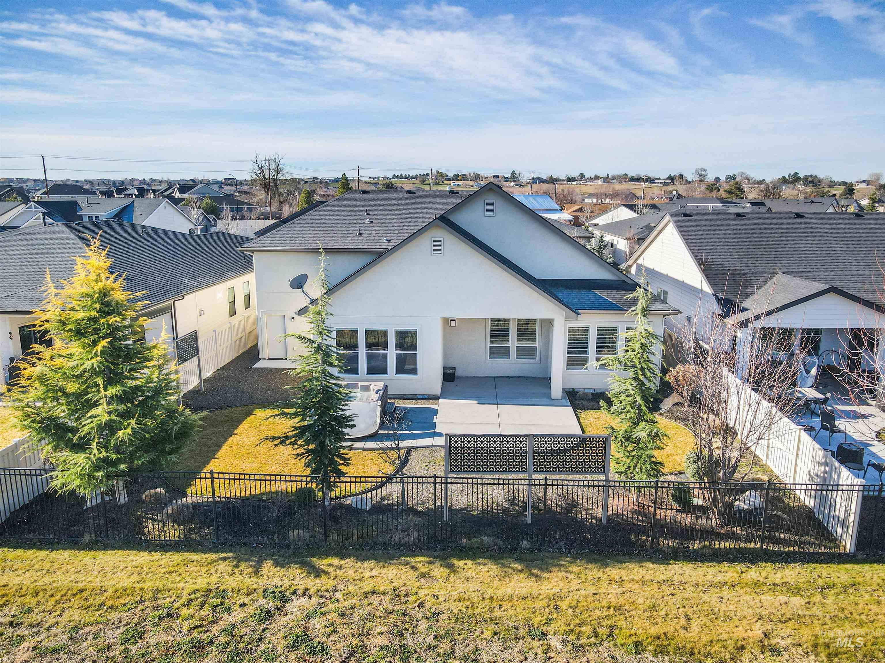 4676 South Abbot Meridian, ID 83642 - Photo 7 of 49 Back of house with a patio, stucco siding, a fenced backyard, and a residential view