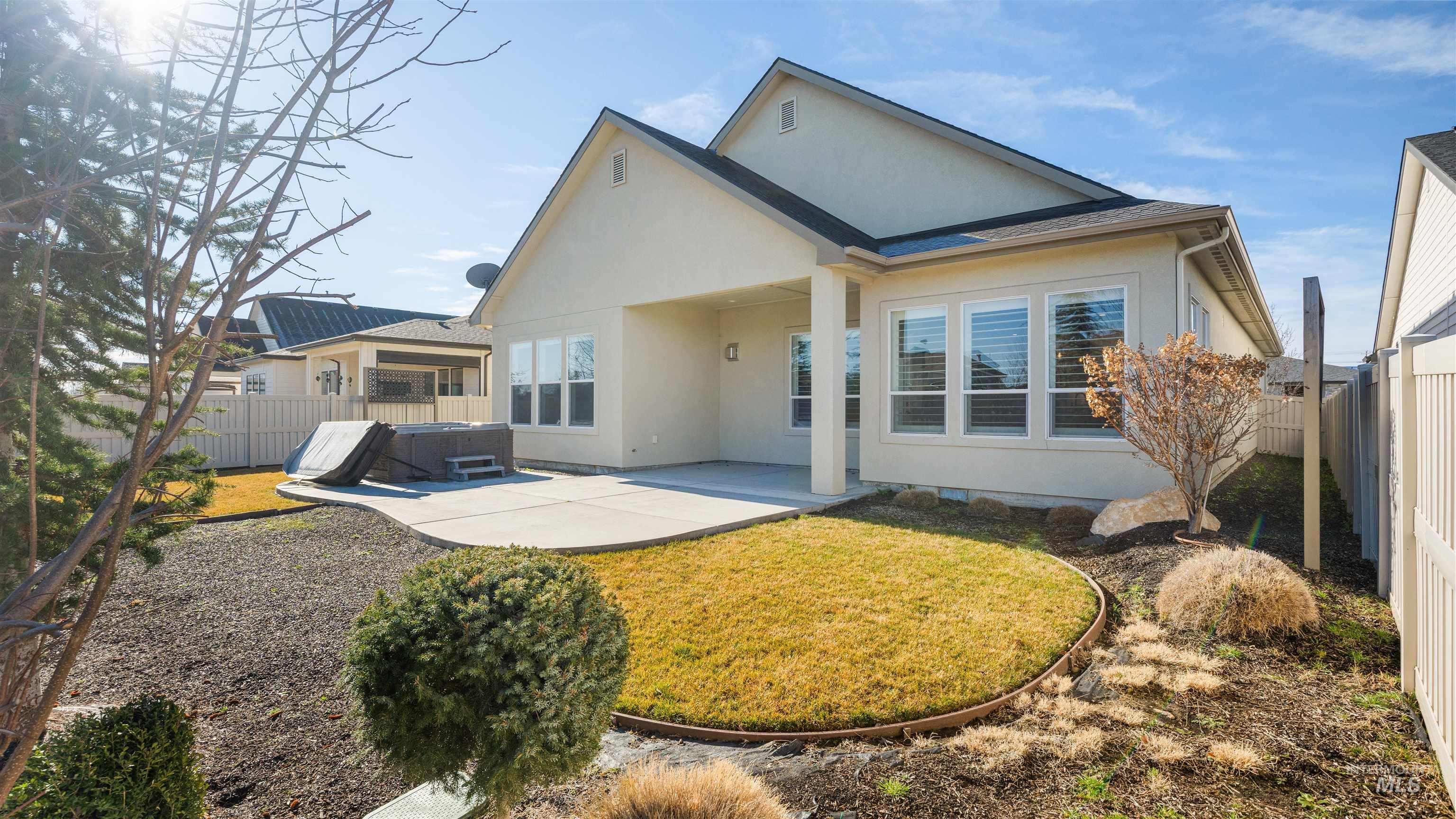 4676 South Abbot Meridian, ID 83642 - Photo 10 of 49 Back of house featuring a patio, a fenced backyard, a hot tub, and stucco siding