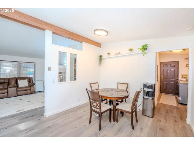 a kitchen with stainless steel appliances granite countertop a refrigerator a stove a sink and a window