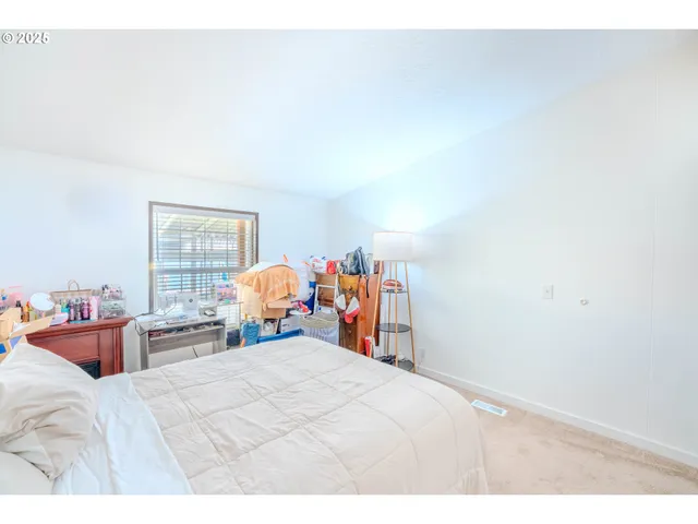 a bedroom with furniture and a wooden floor