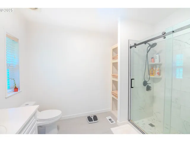 a bathroom with a sink toilet a mirror and shower