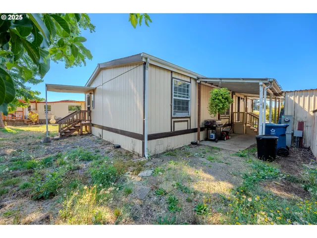 a view of a wooden house with a yard