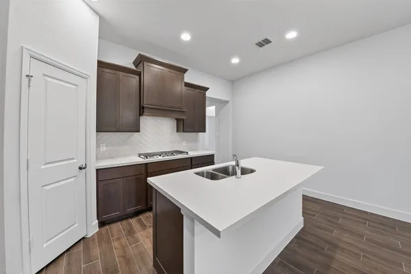 a kitchen with stainless steel appliances a sink and a refrigerator