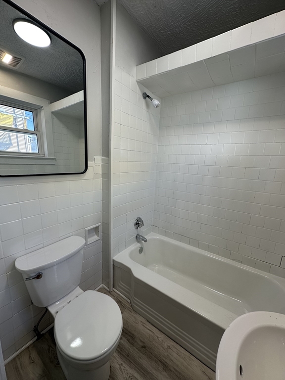 66 Lyon Street, Unit 1 Fall River, MA 02721 - Photo 11 of 11 a bathroom with a toilet a sink and bathtub