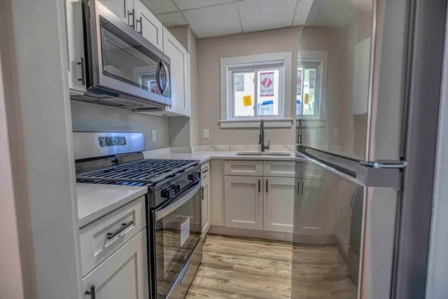 a kitchen with stainless steel appliances granite countertop a stove top oven a sink and dishwasher