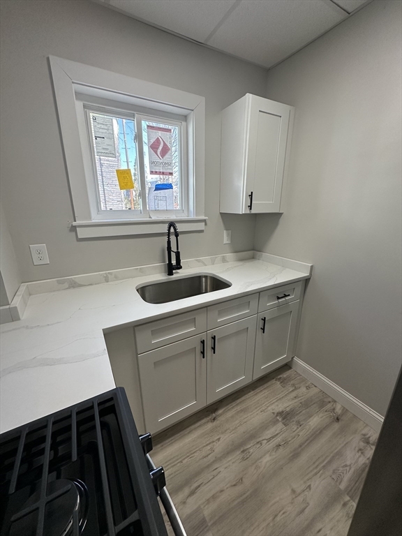66 Lyon Street, Unit 1 Fall River, MA 02721 - Photo 5 of 11 a kitchen with a sink and a stove top oven