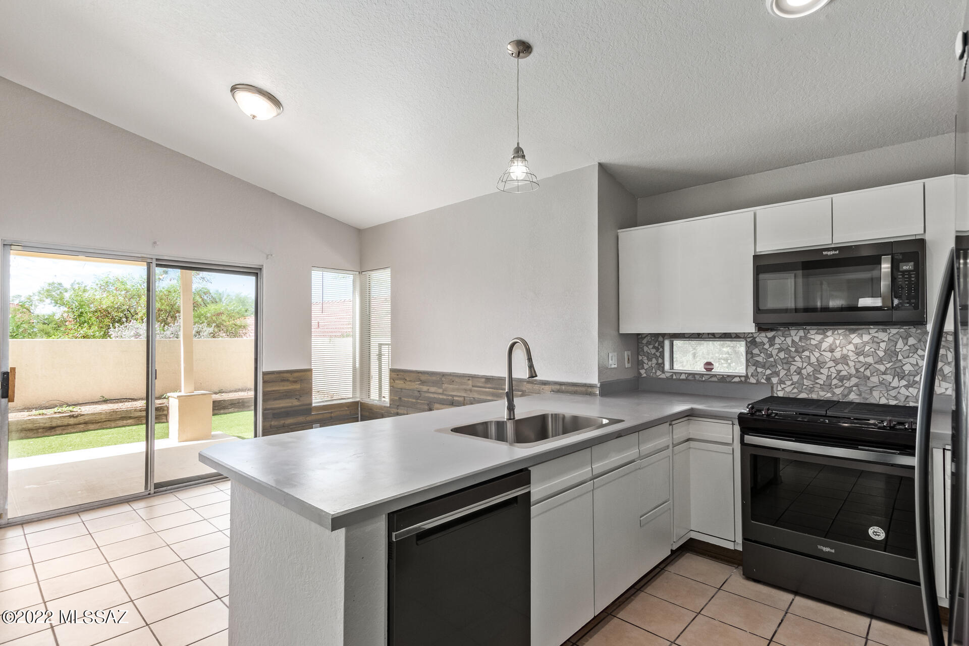 4697 West Weathervane Street Tucson, AZ 85741 - Photo 10 of 25 a kitchen with a sink stove and microwave
