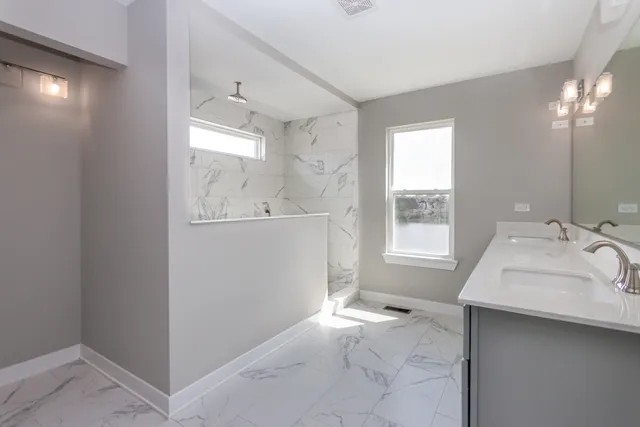 a bathroom with a sink mirror and a bathtub