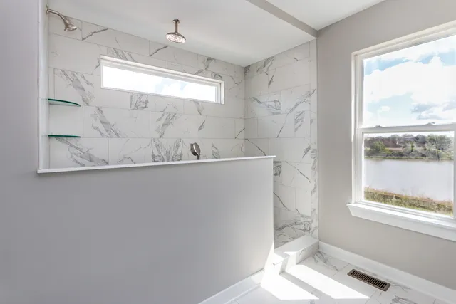 a bathroom with a bathtub and a window