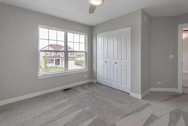 an empty room with windows and closet