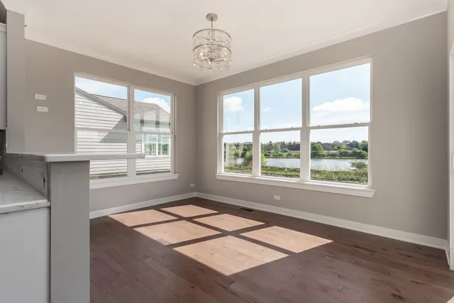 a living room with a window and a chandelier
