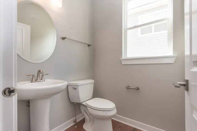 a bathroom with a sink toilet and a mirror