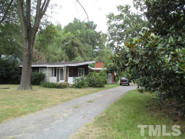 712 Horton Road Durham, NC 27704 - Photo 1 of 6 a front view of a house with a yard and trees