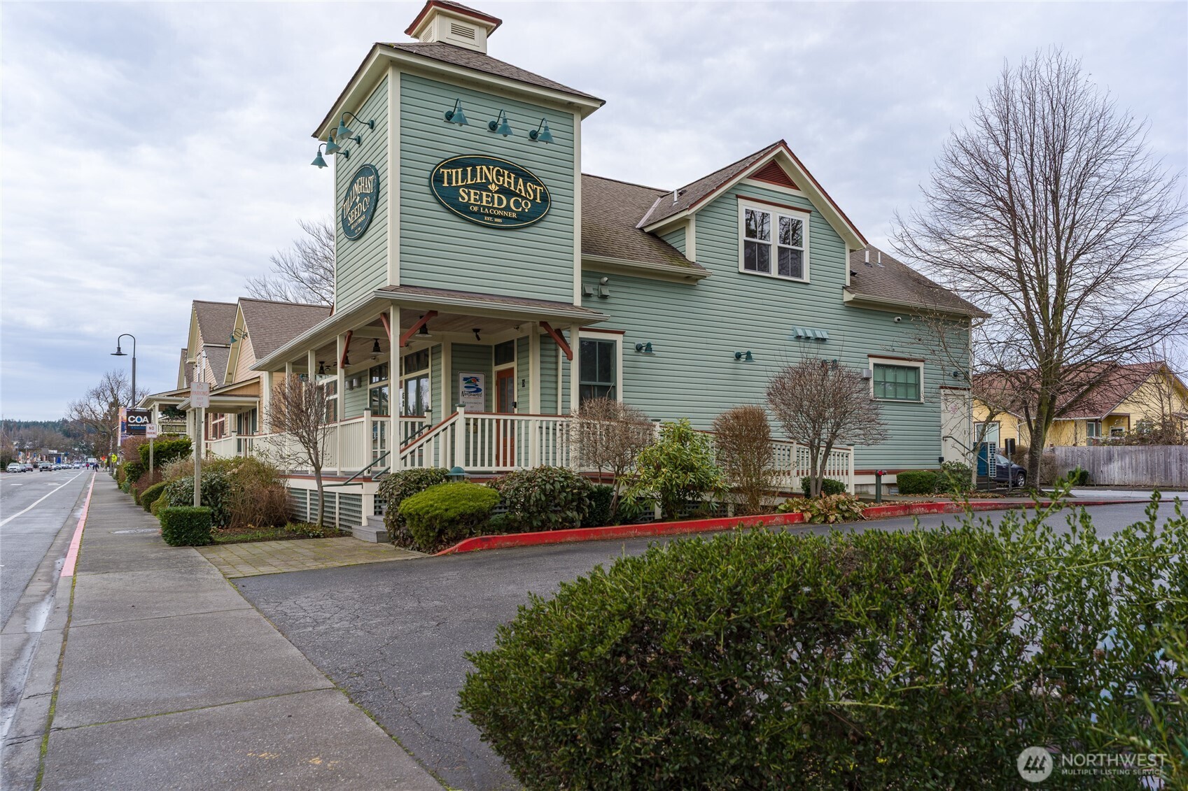 623 Morris Street, Unit E2 La Conner, WA 98257 - Photo 1 of 29 a front view of a house with a yard and garage