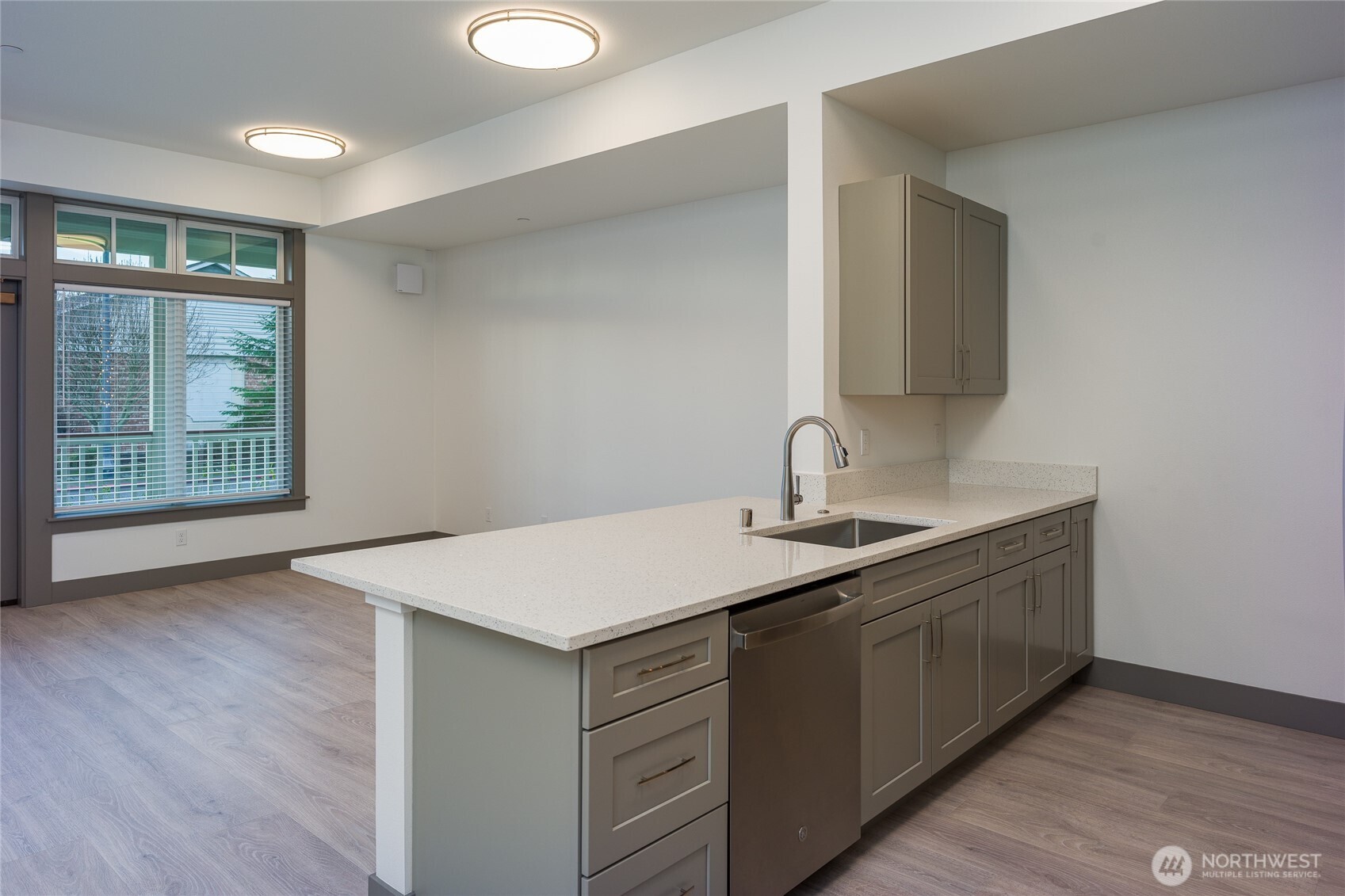 623 Morris Street, Unit E2 La Conner, WA 98257 - Photo 12 of 29 a kitchen with a sink cabinets and wooden floor