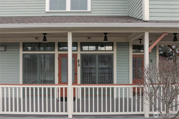 a view of a porch that has a door and a window