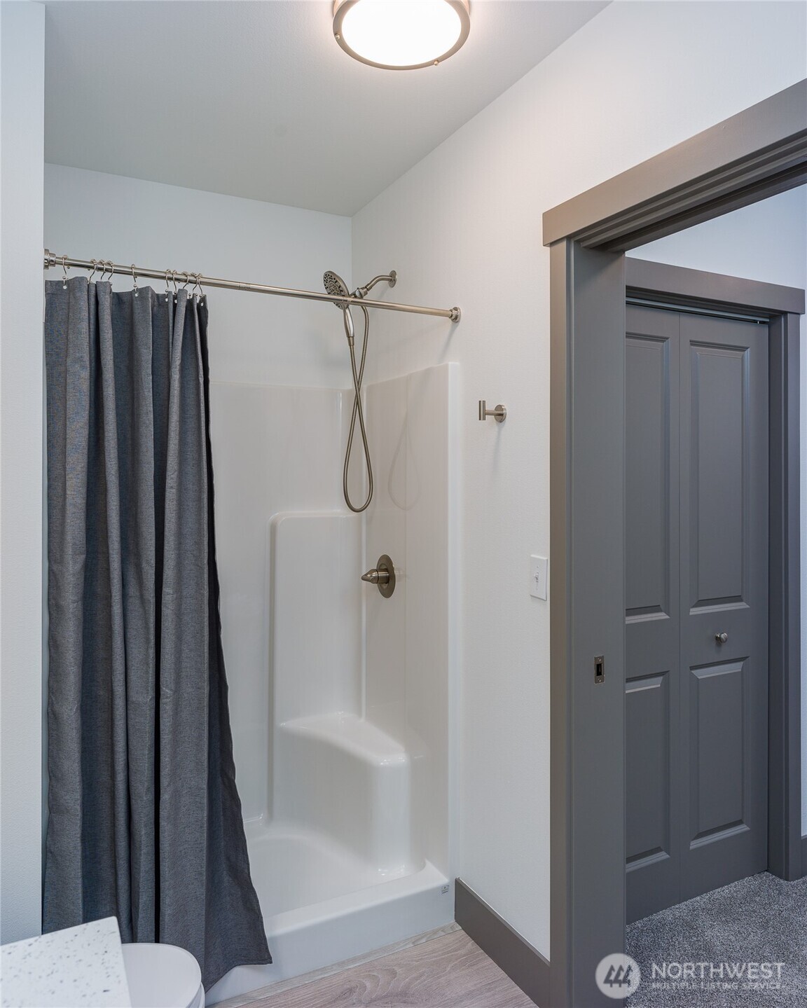 623 Morris Street, Unit E2 La Conner, WA 98257 - Photo 22 of 29 a bathroom with a shower a toilet and sink