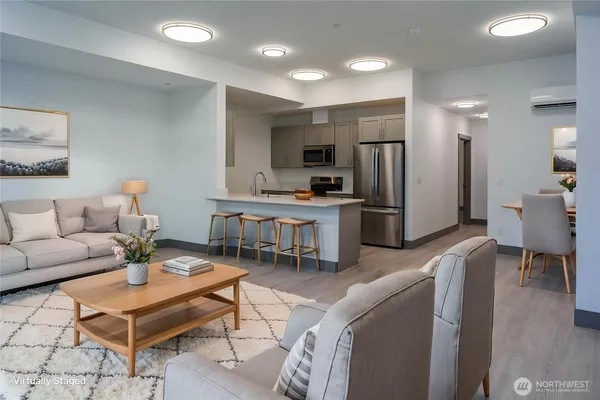 a living room with furniture a refrigerator and a fireplace