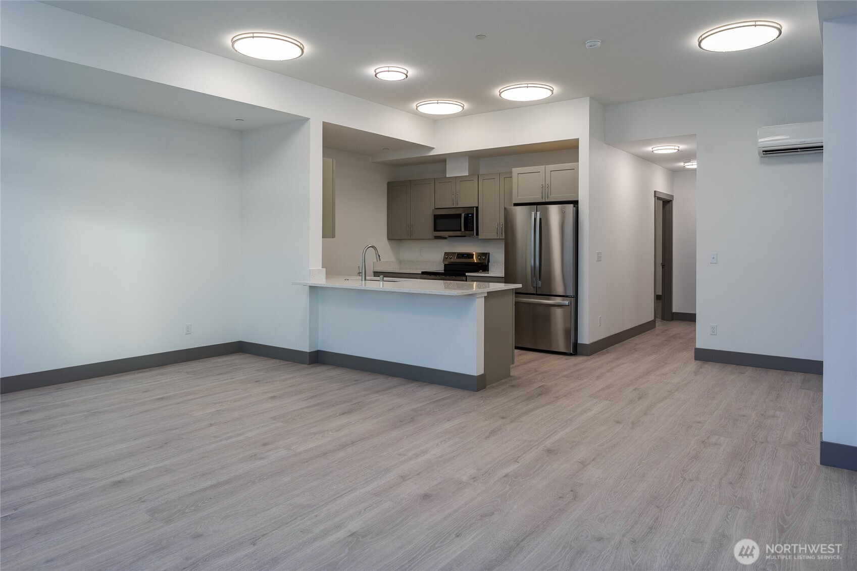 623 Morris Street, Unit E2 La Conner, WA 98257 - Photo 6 of 29 a view of kitchen with refrigerator microwave and stove