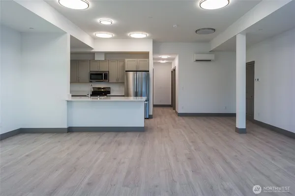 a view of a kitchen with a sink a refrigerator and window